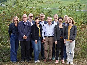 A group of people in a green space.