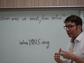 A man in front of a whiteboard.